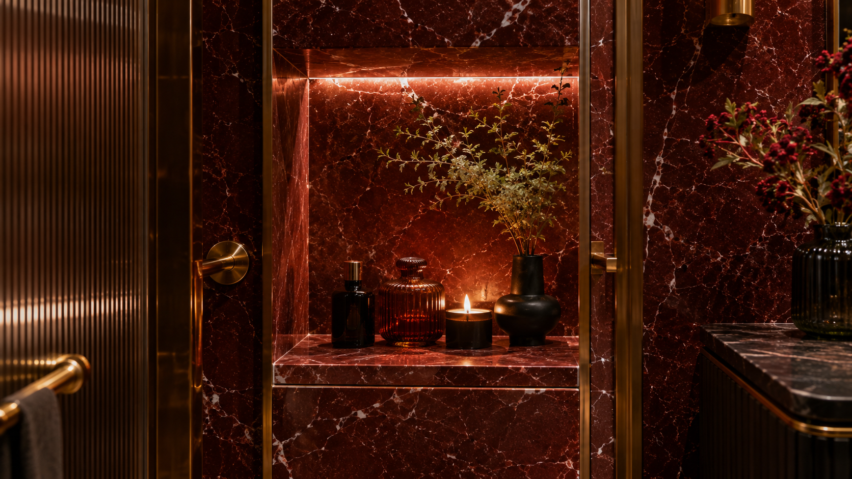 Built in bathroom shower niche styled with red marble shelf inserts and brass trim